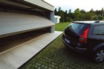 Outward-swinging up-and-over garage door